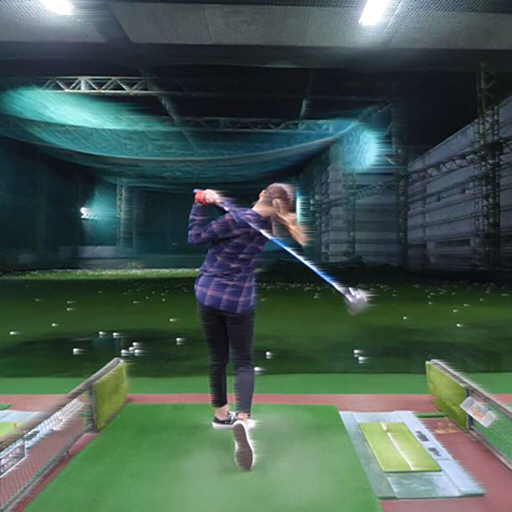 Japanese female golfer at a golf driving range