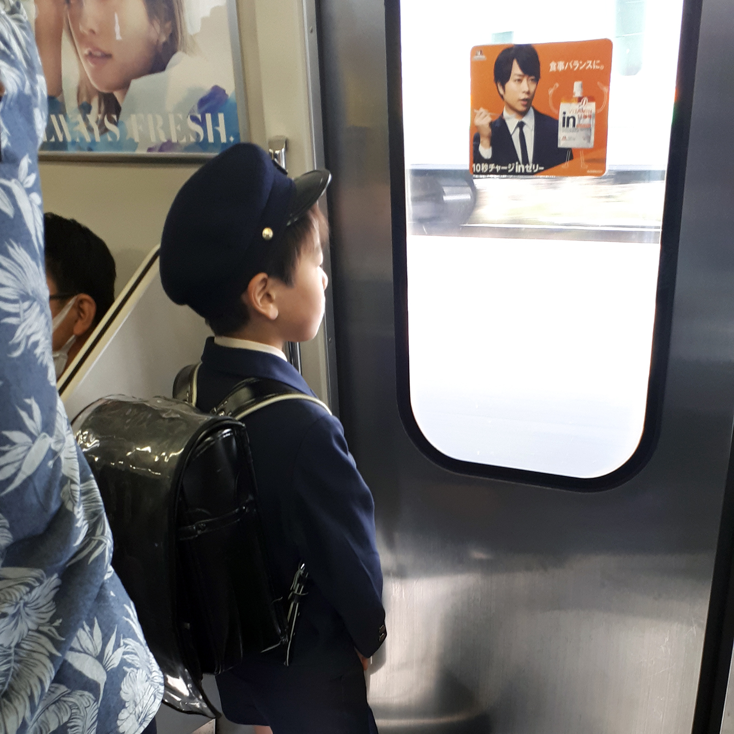 japanese schoolboy with his randoseru on the train
